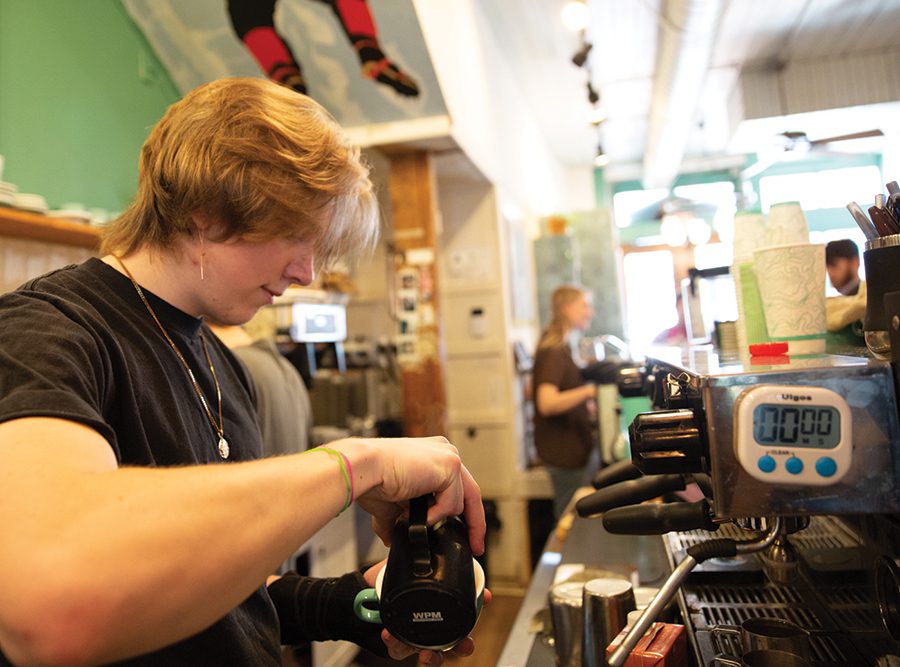 A barista at Summitt Coffee in Davidson, NC prepares a customers order. 