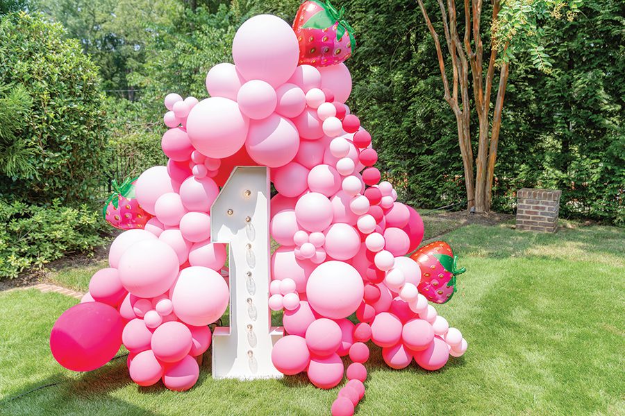 Cascading pink balloon display with a giant, light-up number 1 