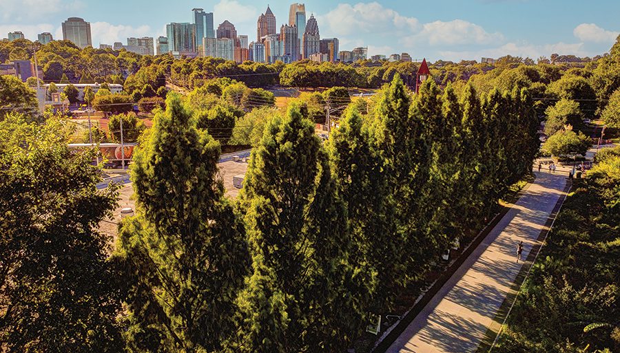 A view of the Atlanta skyline and the BeltLine that cuts through the forest in front of the cityscape