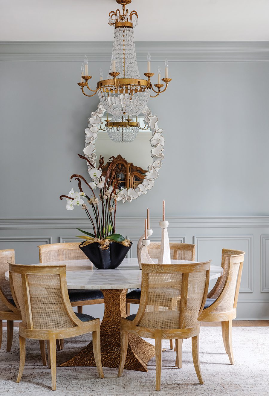 A dining room with a marble table in Foxcroft designed by House of Nomad.