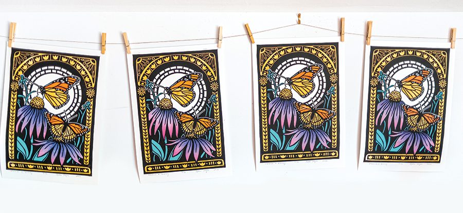 A line of four of the same art print featuring monarch butterflies and purple and pink flowers