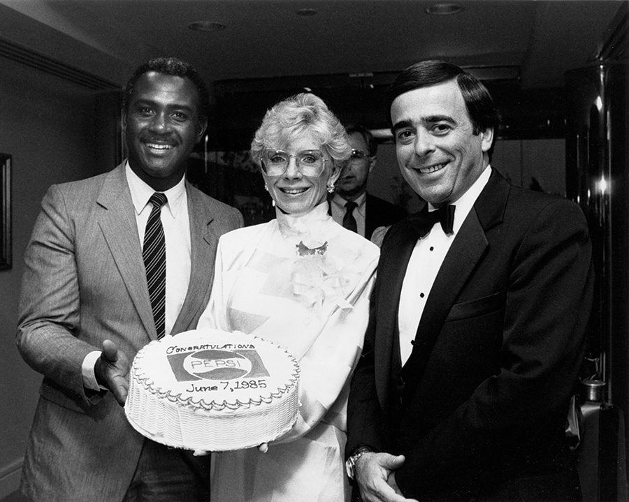 Dale Halton holds a cake celebrating a Pepsi anniversary.