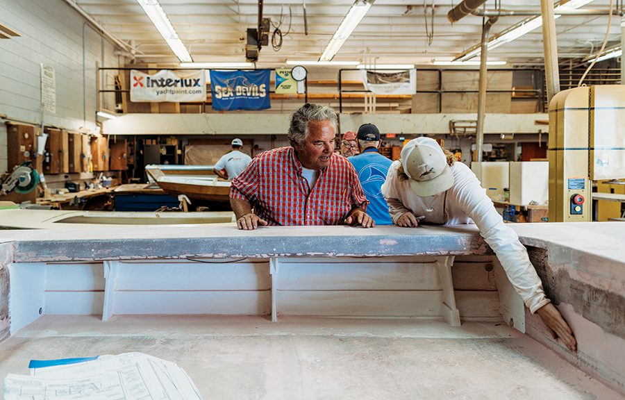 Master shipwright Mark Bayne works on a boat being made at Cape Fear Community College.
