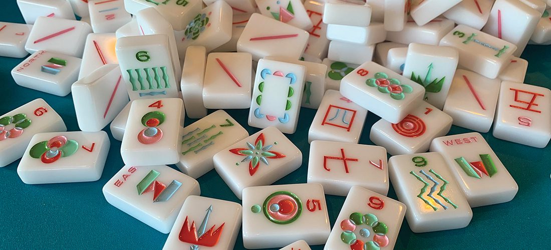 Mahjong tiles on green table