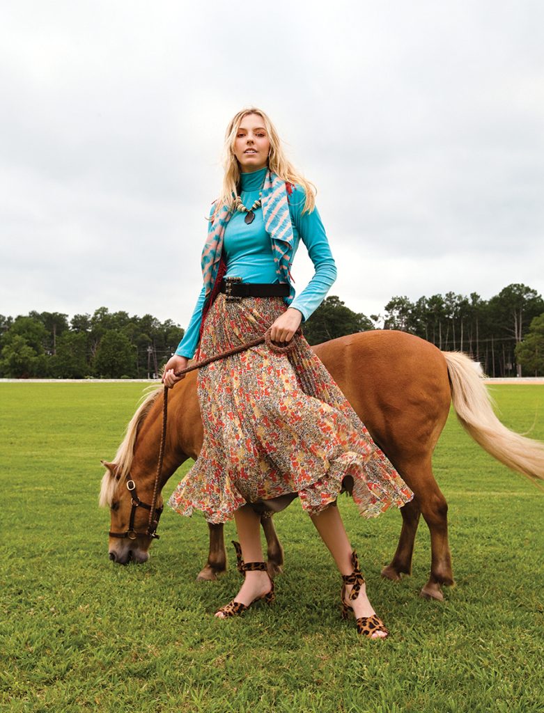Model Elaine Metcalf holding Franklin the miniature palomino at the Pinehurst Harness Track.