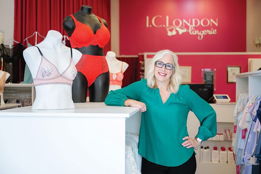 Shelly Domenech, owner of I.C. London Lingerie standing next to merchandise