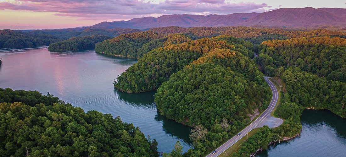 Aerial photo of a road, river and mountains in a Virginia-Tennessee border town. Photograph by Joshua Lee Bryant