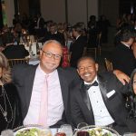 Patrons pose for photos with Muggsy Bogues.