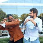 Phil Harslam celebrates with Lydia Thompson by bumping.