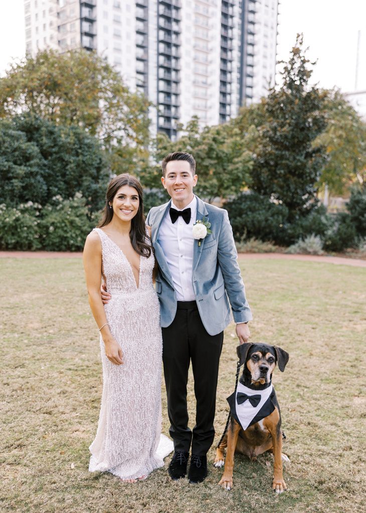 Chloe Leshner Camisa and George Camisa smile big on their wedding day, joined by their rescue pup, Otto, 
