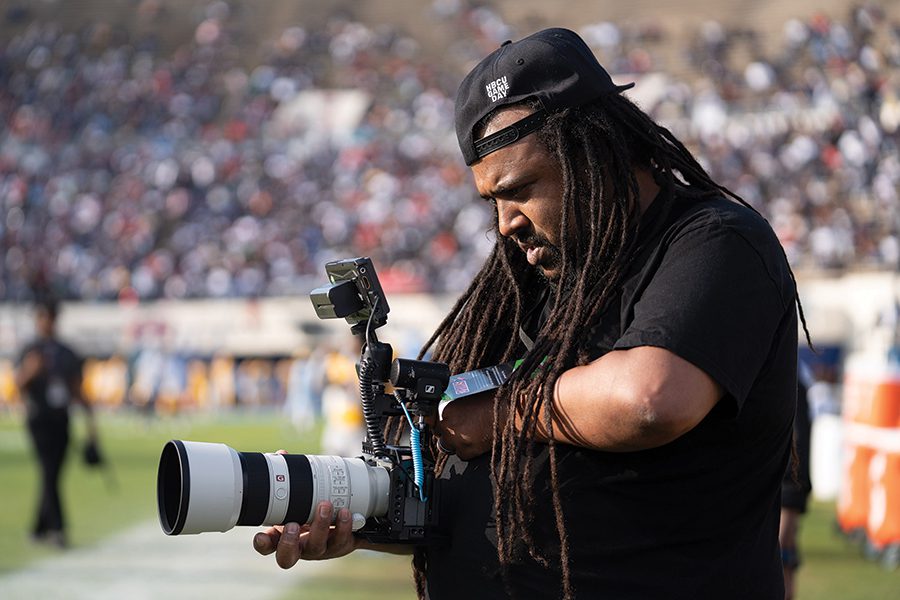 Charlotte filmmaker Wali Pitt takes pictures on the field for HBCU Gameday.