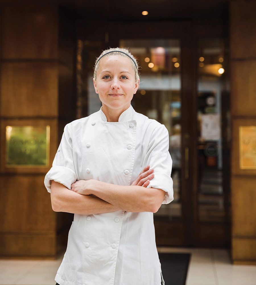 Kaley Laird, executive chef at Mimosa Grill, stands with arms crossed in front of the restaurant