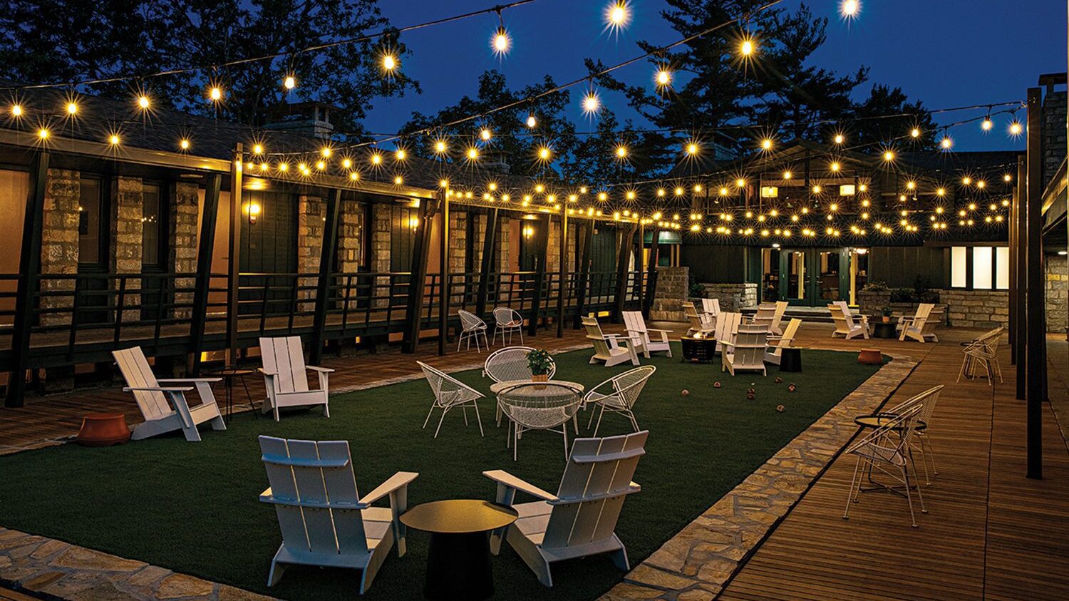 The patio at Skyline Lodge in Highlands, N.C., with string lights at night.