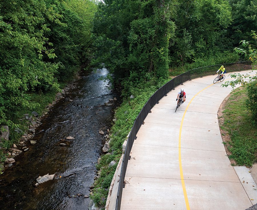 Cyclists ride on a new stretch of the Cross Charlotte Trail behind Park Road Shopping Center.