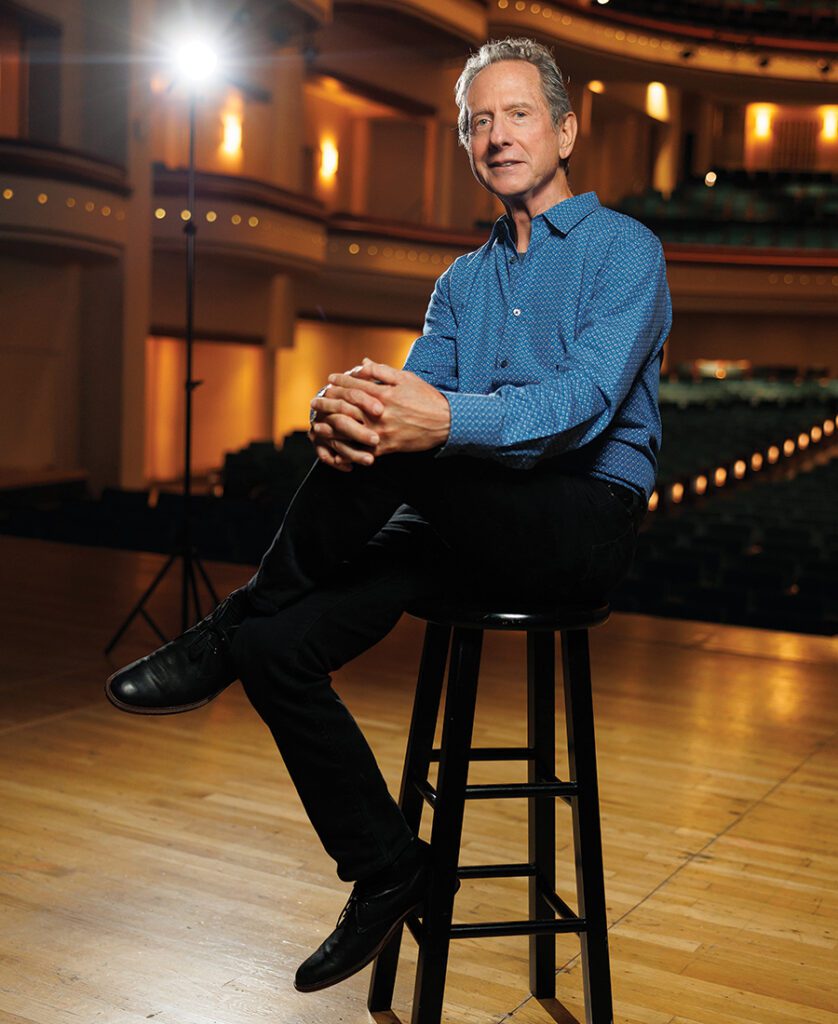 RIck Lazes sits on stage during a photo shoot in uptown Charlotte.