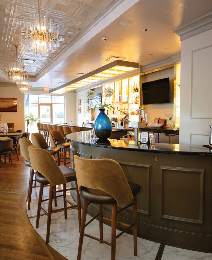 Jim Emad stands at the bar inside his restaurant Bentley's in the SouthPark neighborhood of Charlotte.