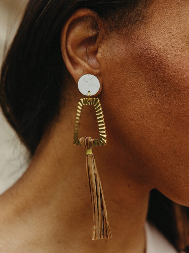 A woman wearing an earring from Braveworks.