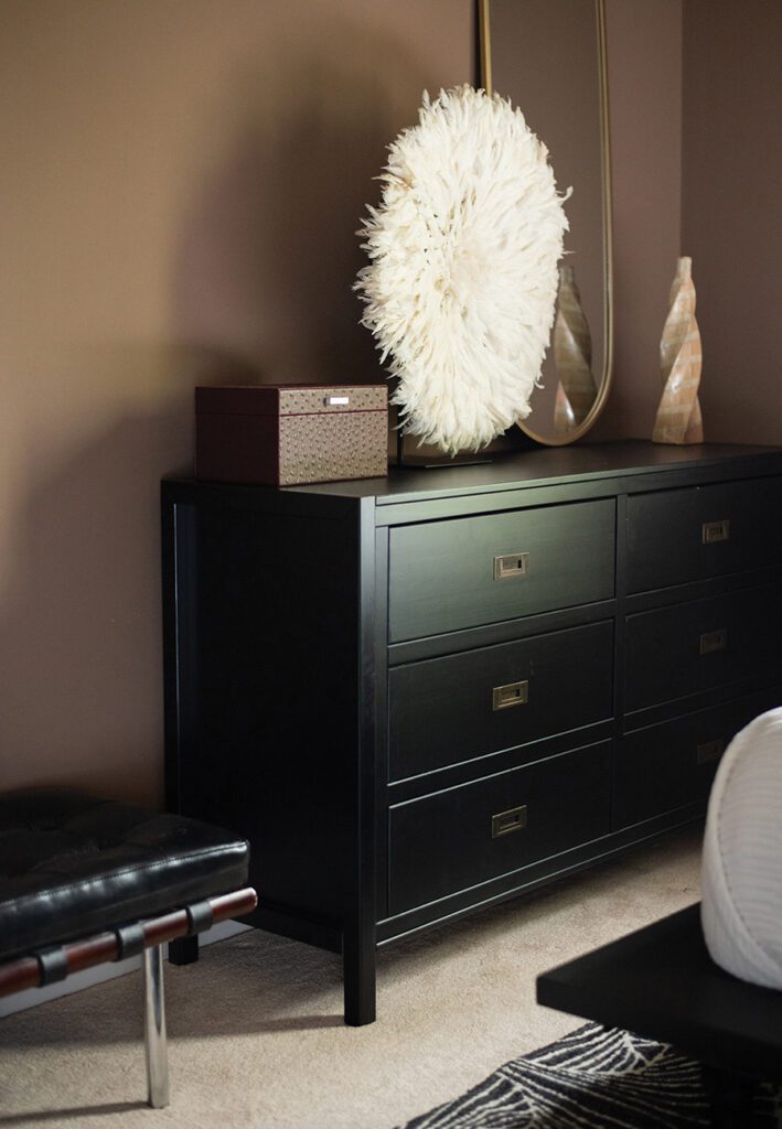 A small desk inside a cozy, modern guest room designed by Marie Cloud.