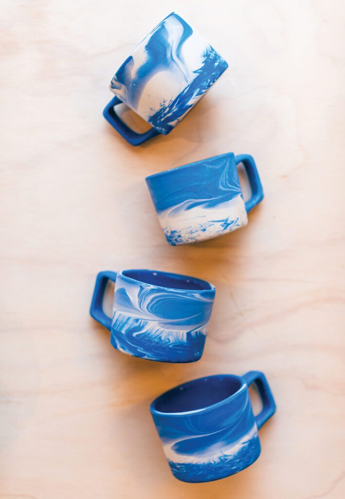 Blue mugs from Haand pottery photographed by Mallory Cash