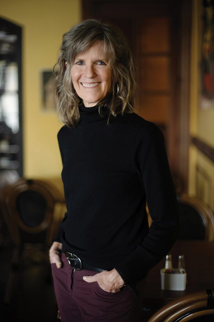 Molly Barker standing inside one of her favorite Charlotte restaurants, Cafe Monte.