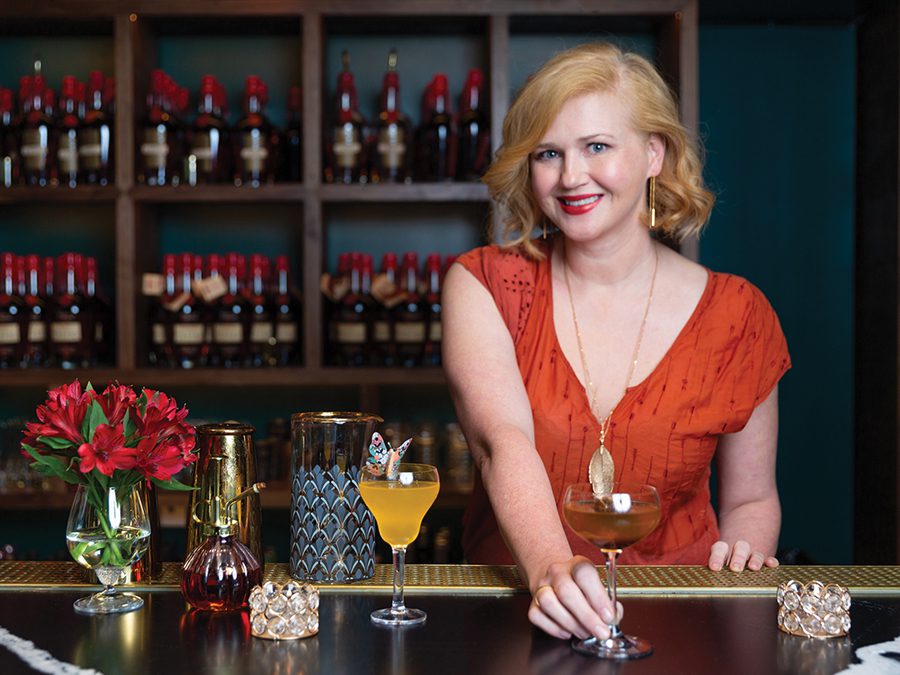 Colleen Hughes, beverage director at Supperland, at a bar with a cocktail