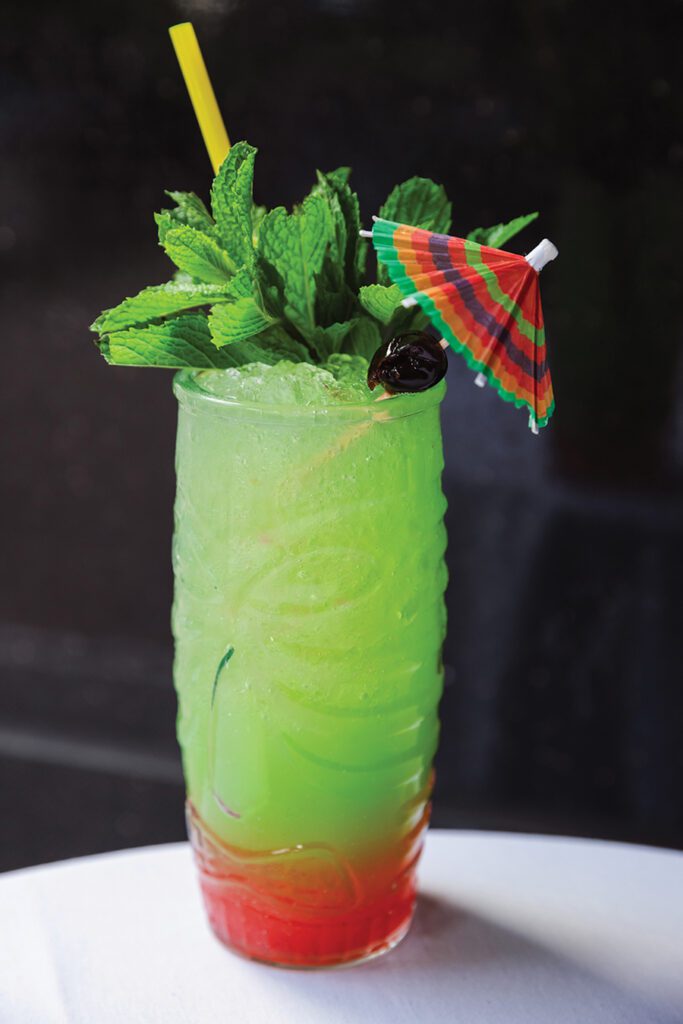 A Fin & Fino cocktail with red and green coloring