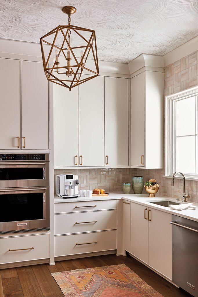 Kravet wallpaper on the ceiling of this scullery adds interest to the design.