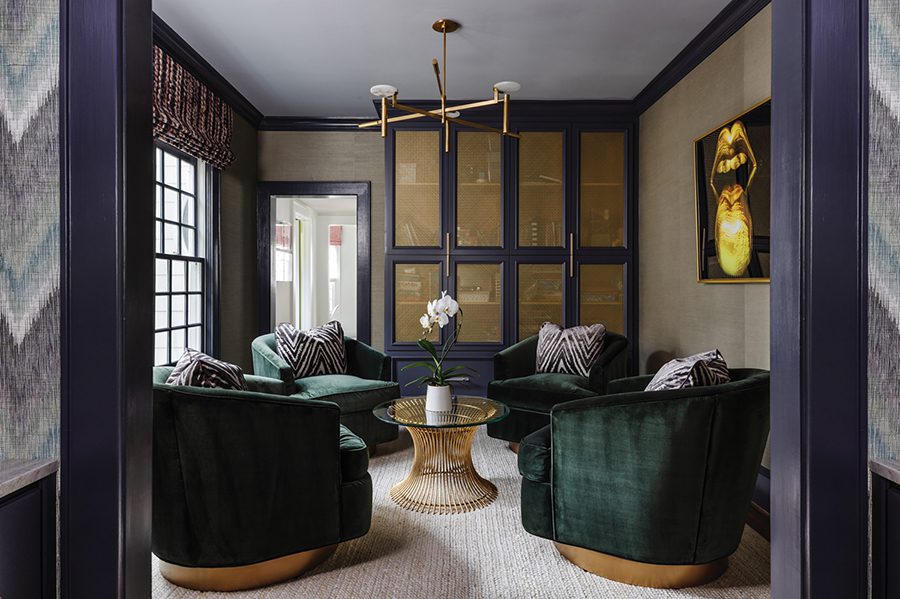 Green velvet swivel chairs by Rowe surround a Worlds Away table in the study of this Myers Park home. The modern light fixture is by Visual Comfort.