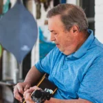 Musician David Childers playing guitar on porch