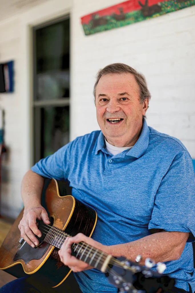 Musician David Childers playing guitar on porch