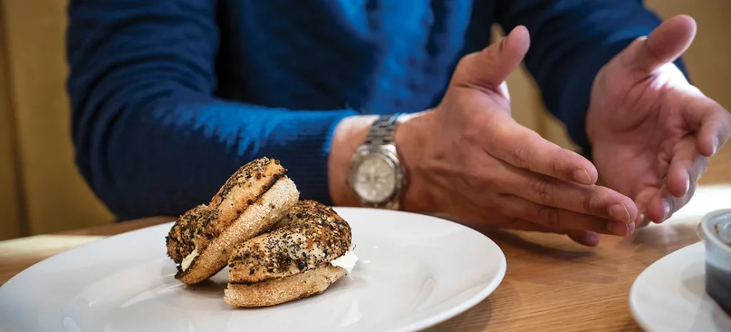 Quail Hollow Club’s director Adam Sperling with bagel from Rhino Market