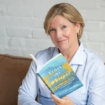 Kathy Izard holding newest book, Trust the Whisper