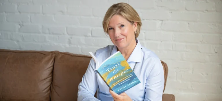 Kathy Izard holding newest book, Trust the Whisper