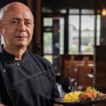 Chef Bruno Macchiavello holding plate of food