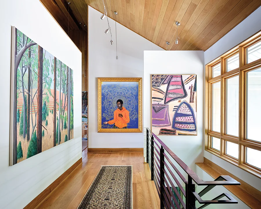 At the end of a corridor, a painting by Kehinde Wiley (“The Reluctant Messiah,” 2002) commands attention. The painting to the right is “Composite 91-14” by Ida Kohlmeyer. The painting on the left, “Straw Field Spring,” is by Maud Gatewood.