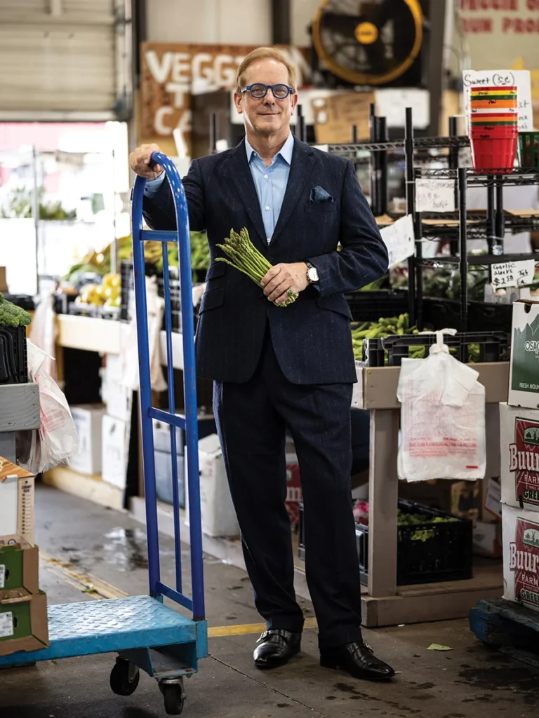 Shayne Doty holding a bundle of asparagus