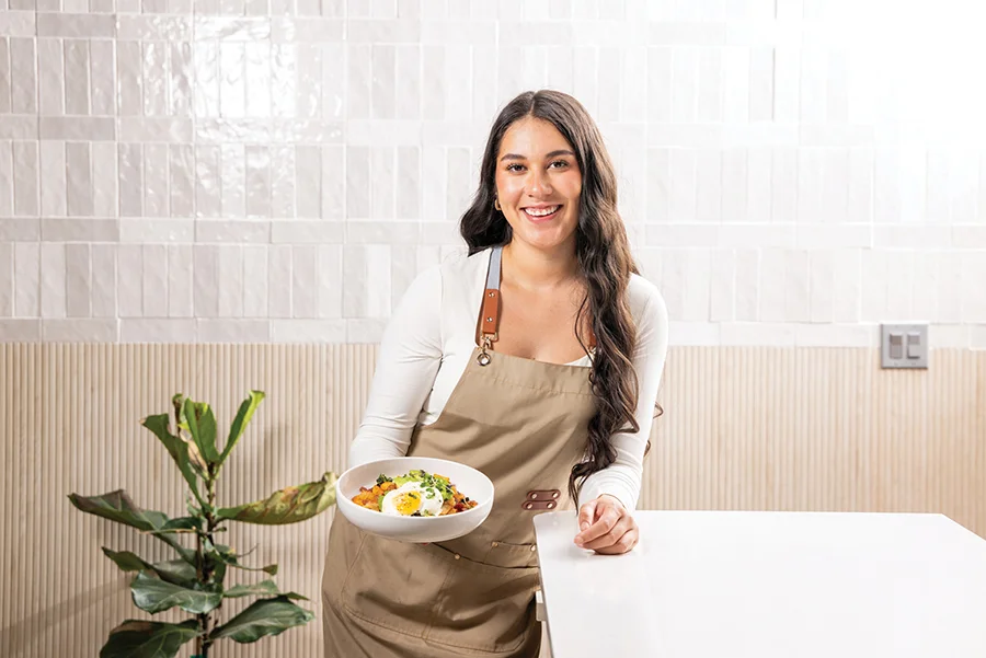 Chef Maria Martinez holding a version of the Lottie’s Cafe brunch staple called “Hugo’s” Hash