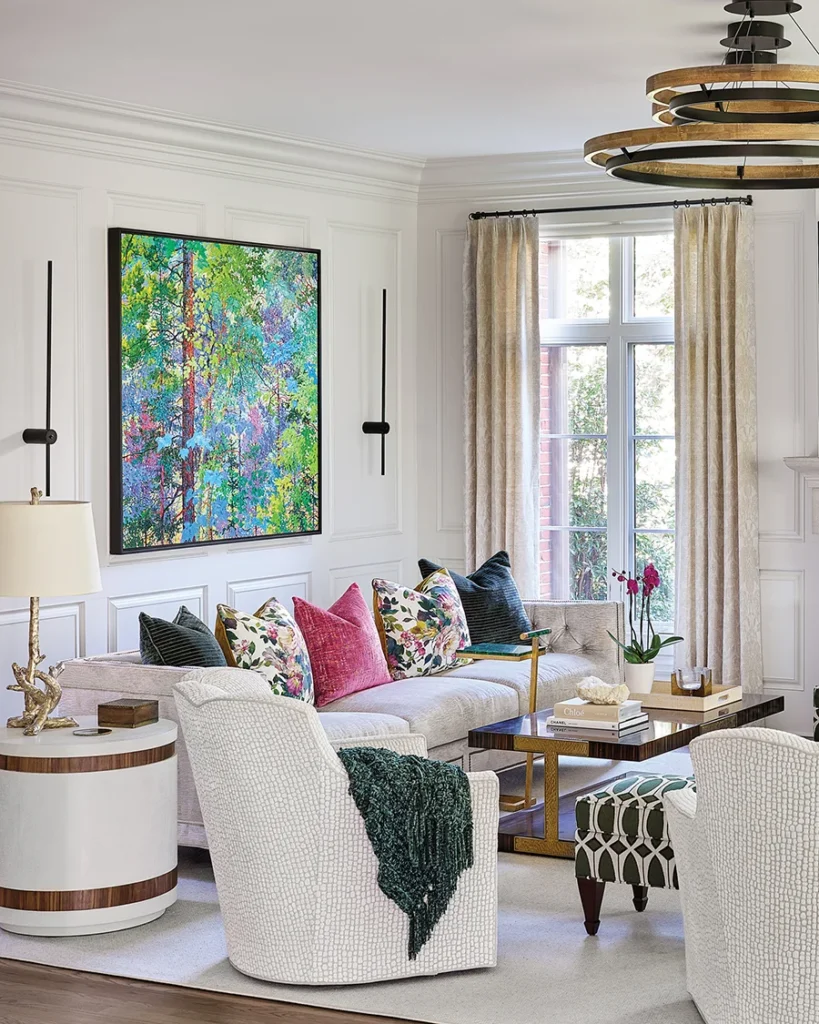 A boldly colored painting purchased from a friend was the inspiration for the living-room design scheme. The custom 110-inch sofa provides plenty of seating for entertaining. The coffee table is by Modern History.