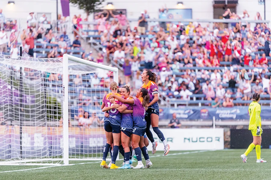 Teammates celebrate the winning goal at the home opener of the Carolina Ascent pro women's soccer team in Charlotte.