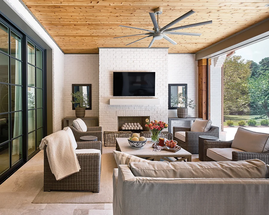Open patio with tv and couches of this Traci Zeller styled home