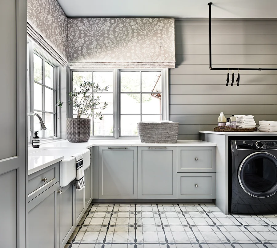 Originally planned as a home office, the spacious laundry room in the rear corner of the home is filled with natural light.