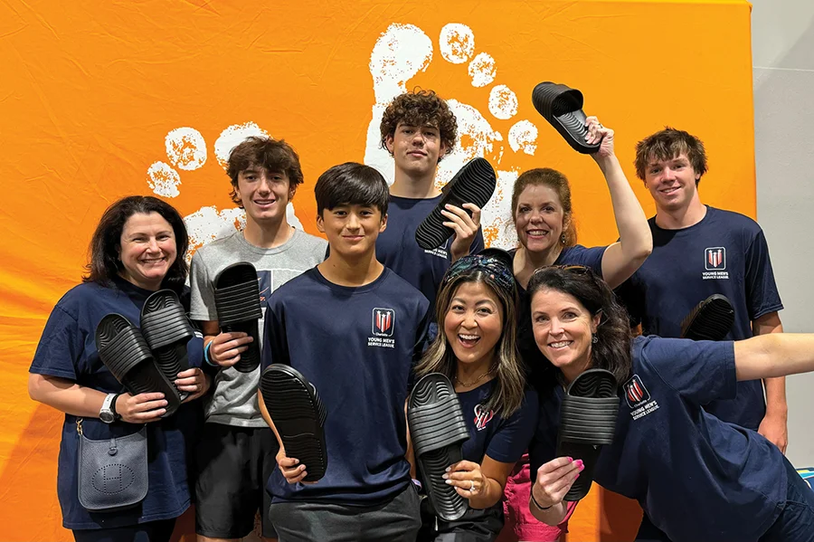 Moms and sons holding shoes