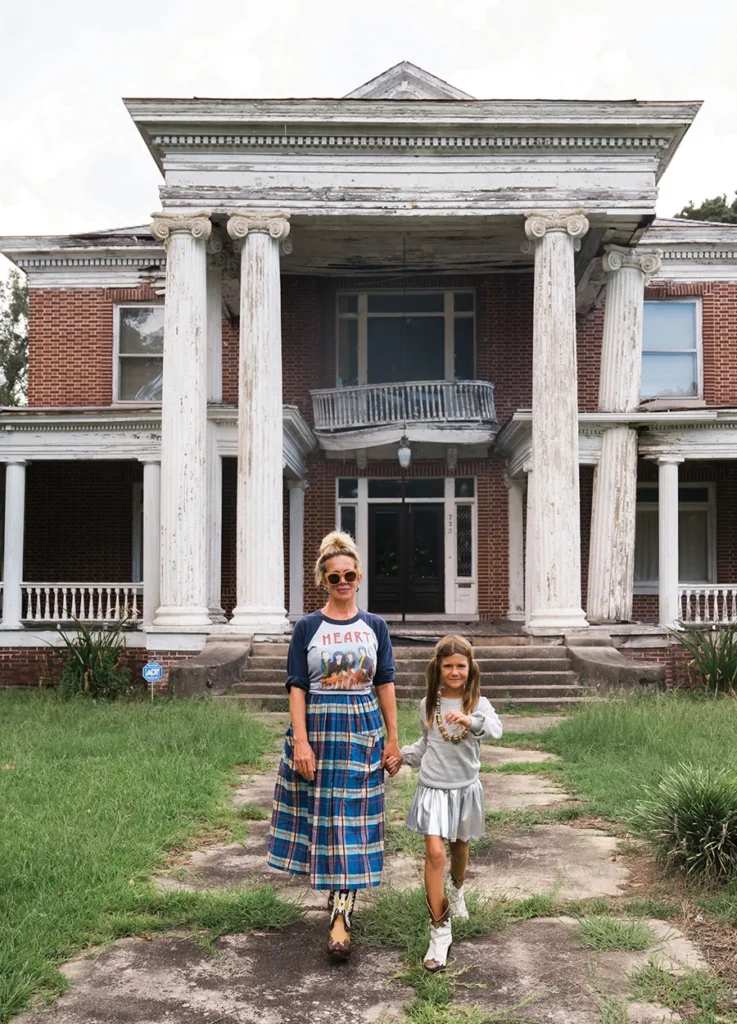 Natalie and Eva walking away from a old house