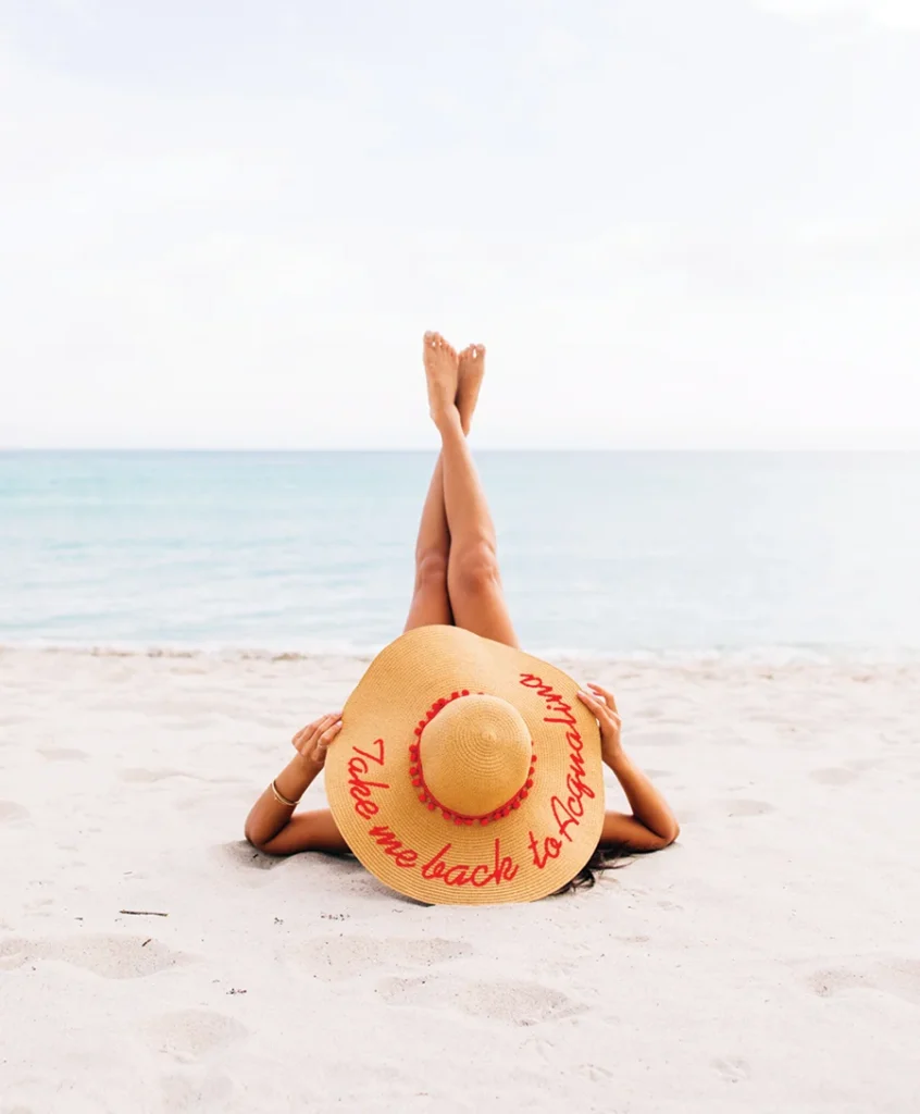 Acqualina lady in sunhat on beach