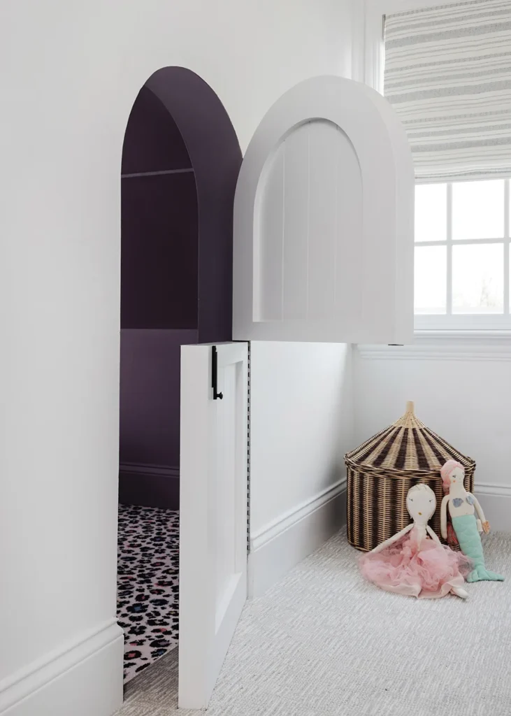 A custom Dutch door carved into the eaves of the playroom leads to a tiny secret playhouse.