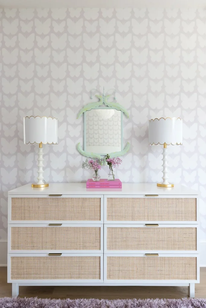 Above a dresser from PB Teen, a mirror from Stray Dog Designs is flanked by lamps by Old World Designs.