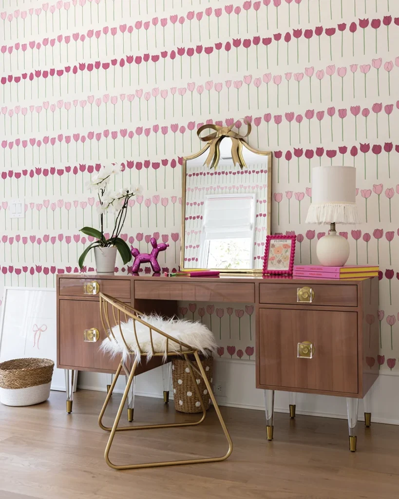 The lacquered desk is from Anthropologie; the gold chairs are from Elk Home. A fun fringed lamp was sourced from Target.