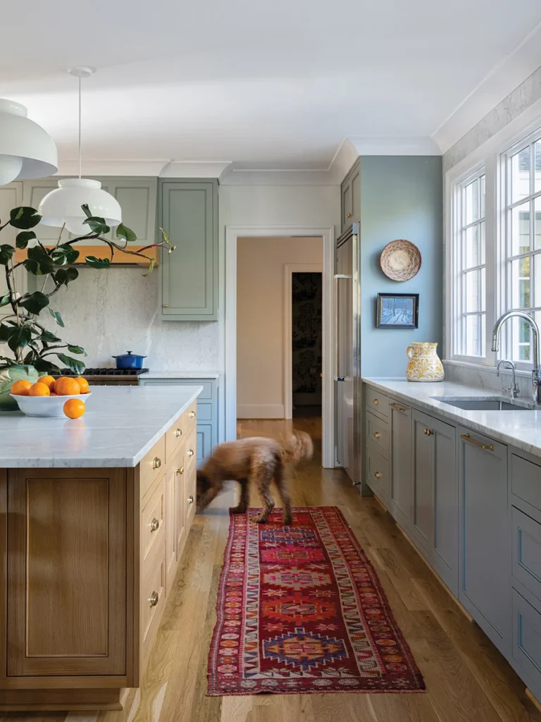 The kitchen runner was sourced from a rug dealer in Athens, Greece. The cabinet paint color is Farrow & Ball Pigeon.