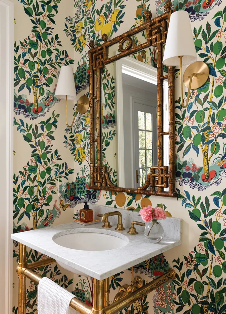 In the powder room, Schumacher’s Citrus Garden wallpaper provides a colorful backdrop for a vintage mirror Stephanie bought in Weaverville after picking up her children from summer camp.