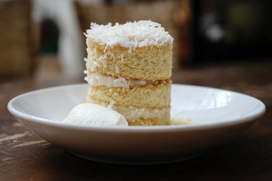 Rooster’s coconut cake with cream-cheese frosting and crème anglaise